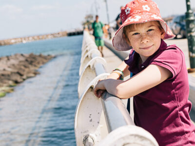 Kid on St Kilda Foreshore beach pier sun child happy